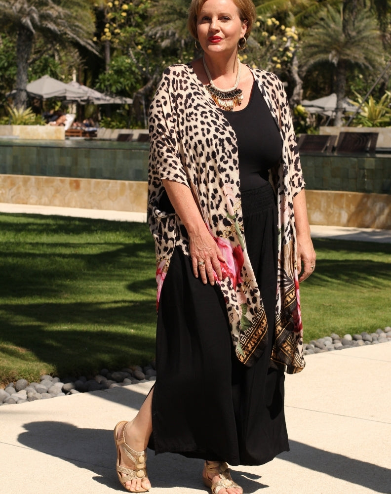 resort pant in black rayon with side leg split worn with kimono for a resort look