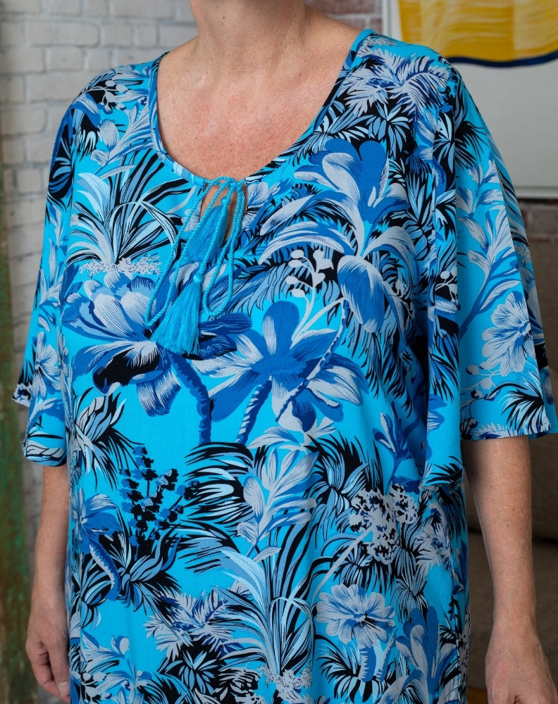 woman wearing blue tropics flutter shift style dress showing neckline tie detail