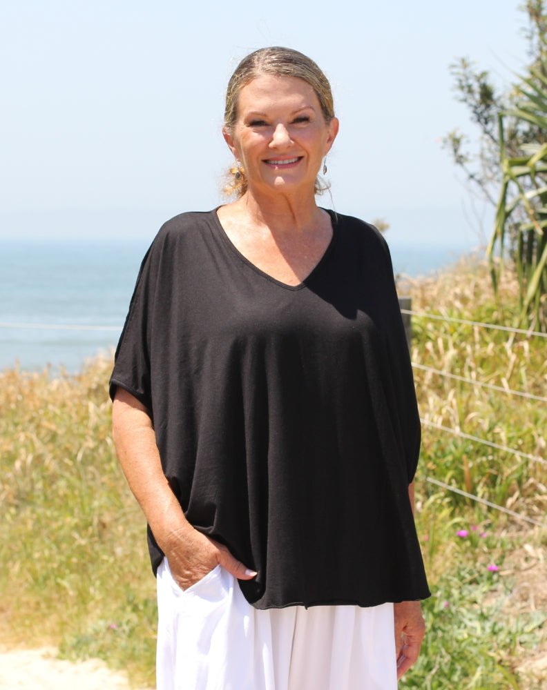 cold shoulder top in black modal close up of hem detail