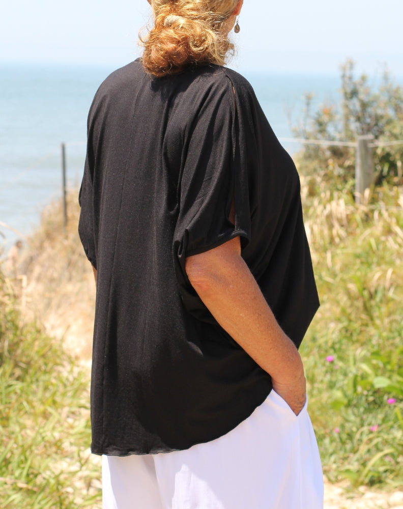 cold shoulder top in black modal showing modest curve length