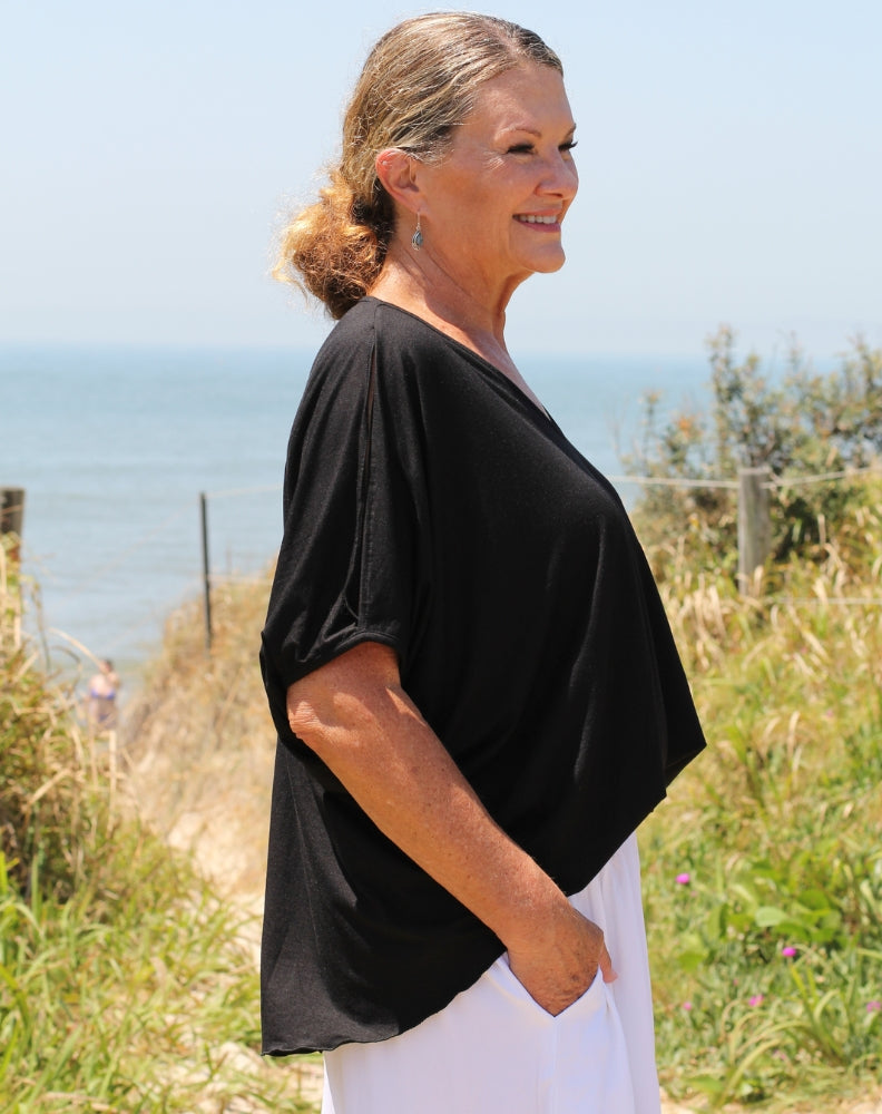 cold shoulder top in black modal showing how to wear tucked in as a drap style tee