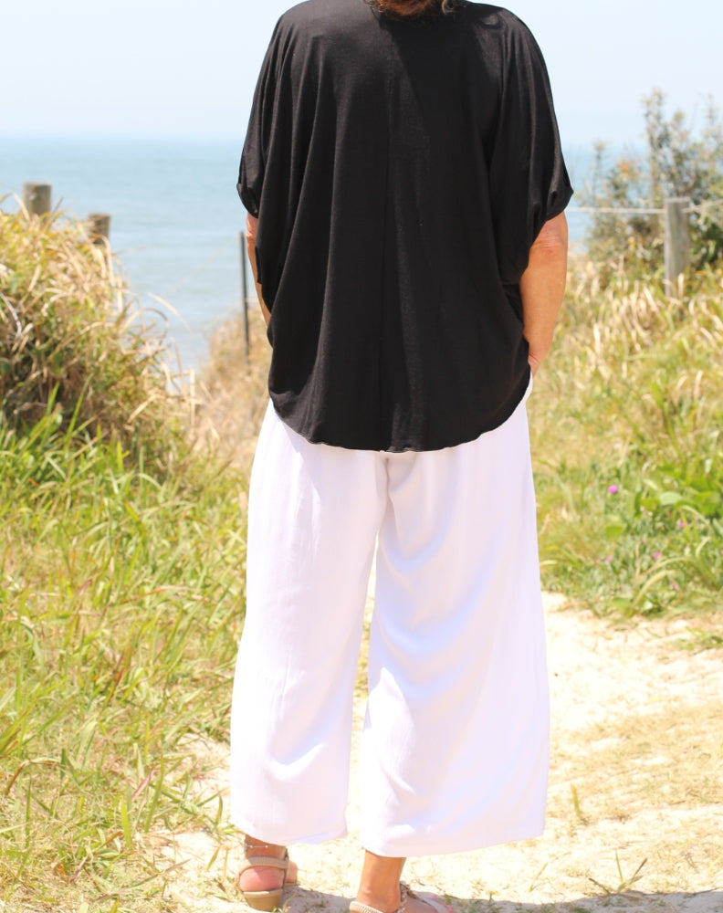 everyday pant in white pictured is the back of the pants worn at the beach