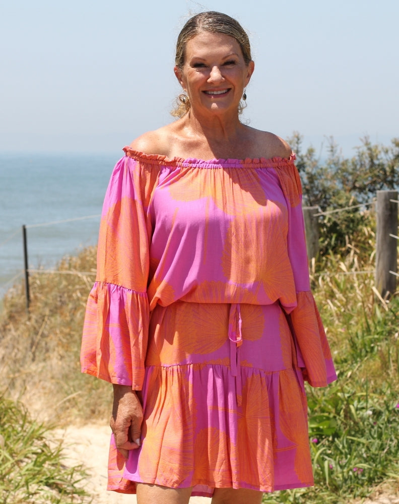 fiesta dress in orange palms worn off the shoulder for beach holidays