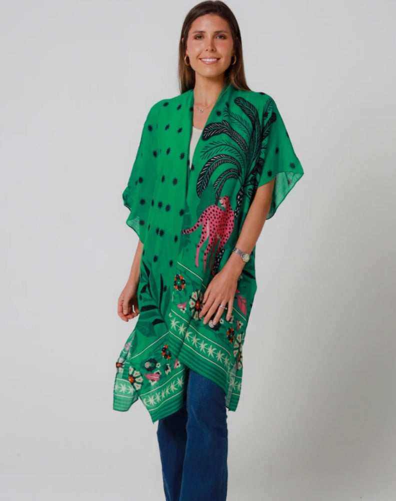 Woman wearing a green patterned kimono styled with white tee