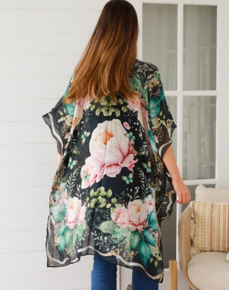 size 10 woman wearing kimono with black floral print