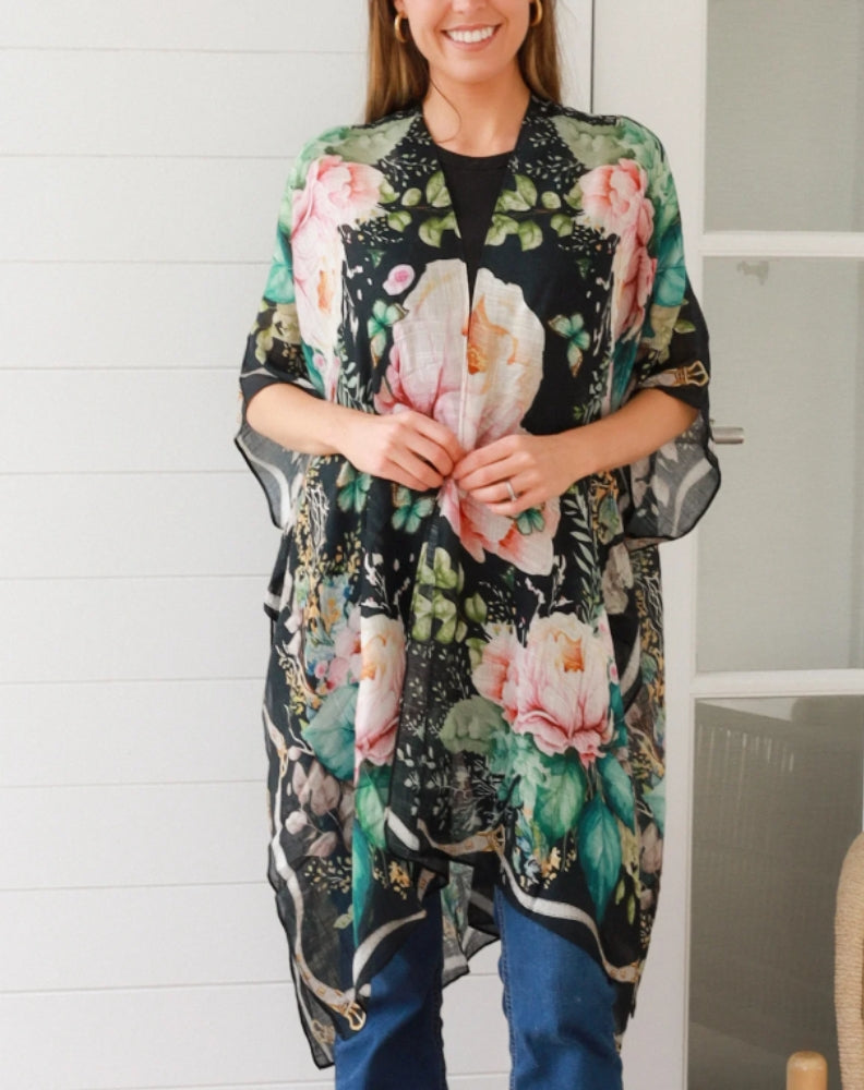 Woman wearing a black floral kimono in a kitchen setting