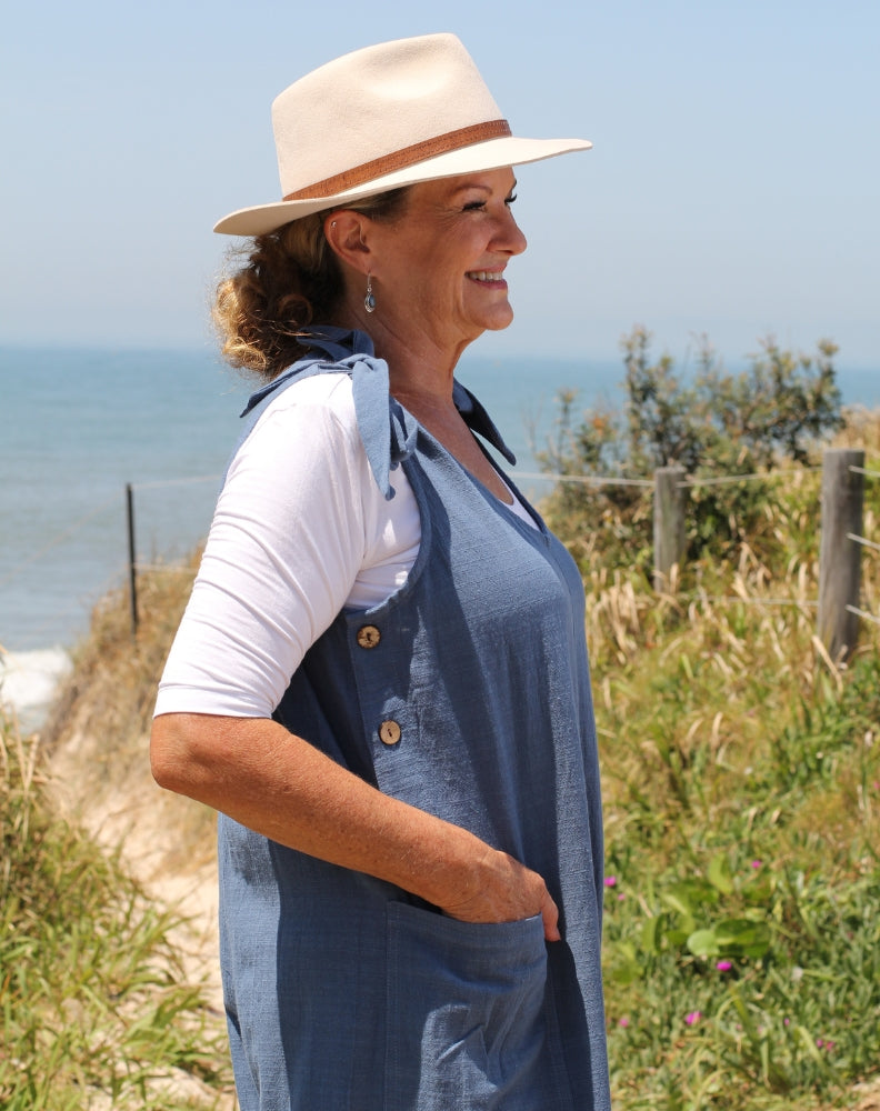 tiestrap jumpsuit in denim by miss seafari showing front pockets and side buttons