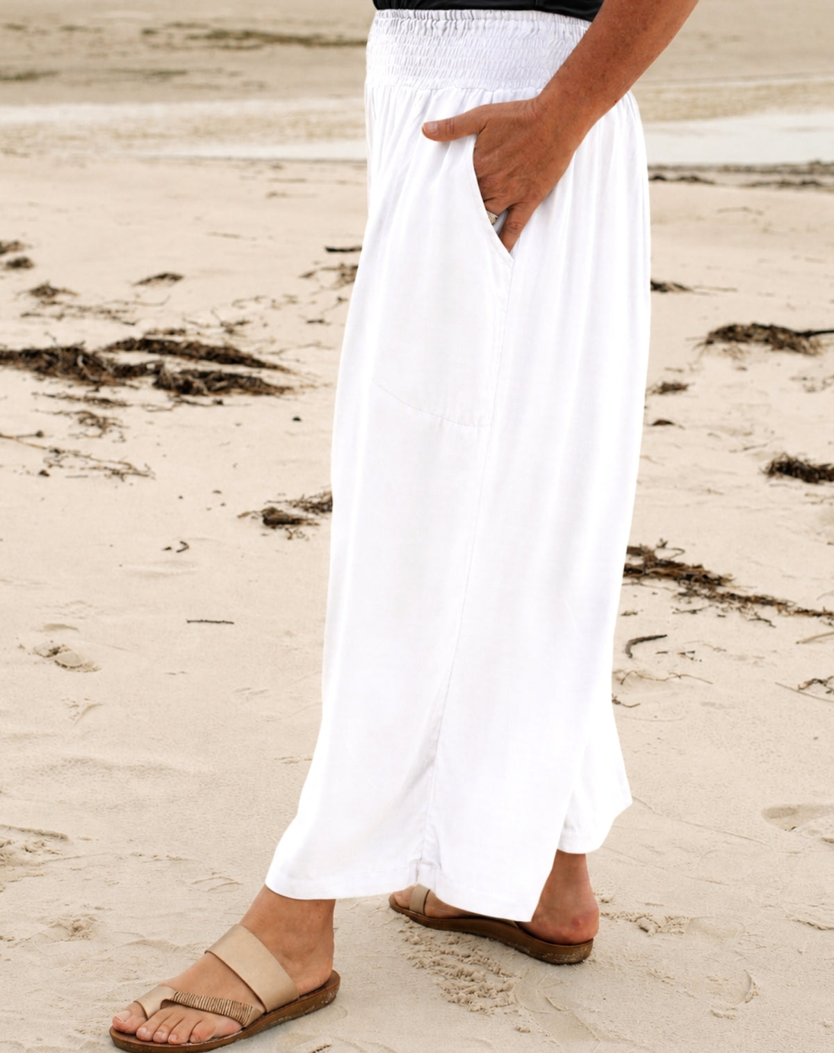 woman on sand in beach pants with wide leg and deep pockets in colour white