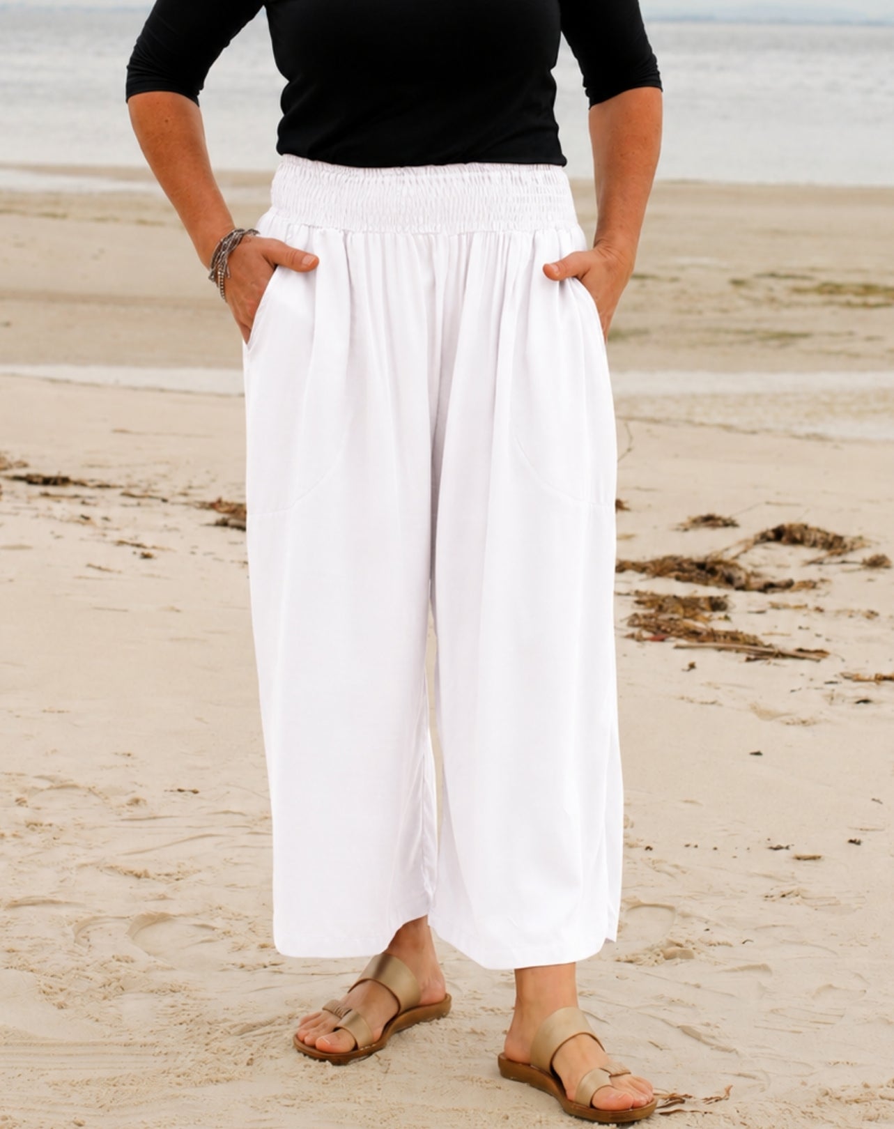 wide-leg white shirred waist 7/8 everyday pant in white worn at beach