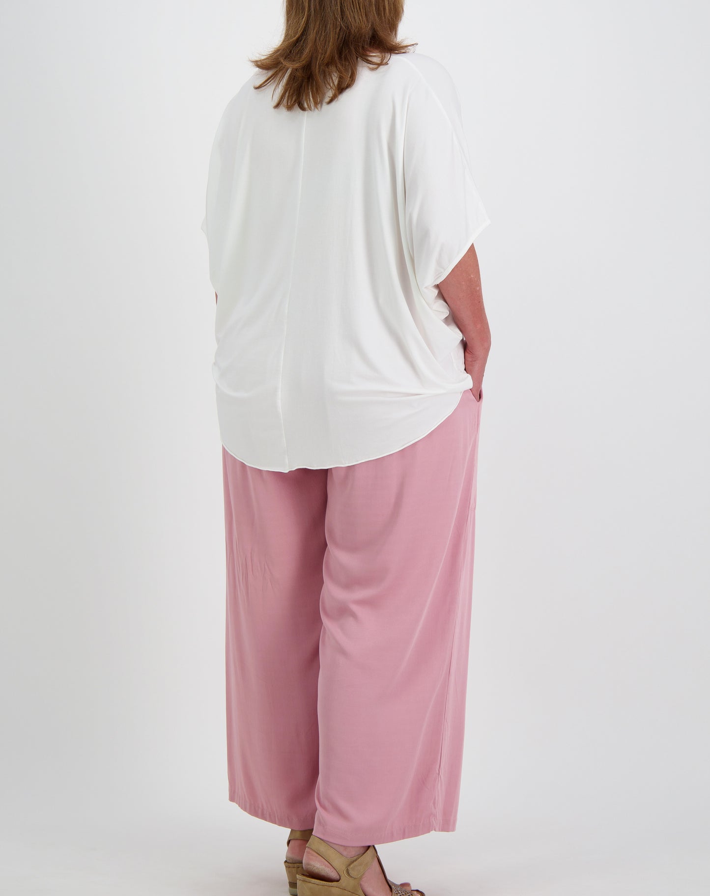 size 16 woman  wearing a white comfort  top in modal and everyday pants in blush on a white background 