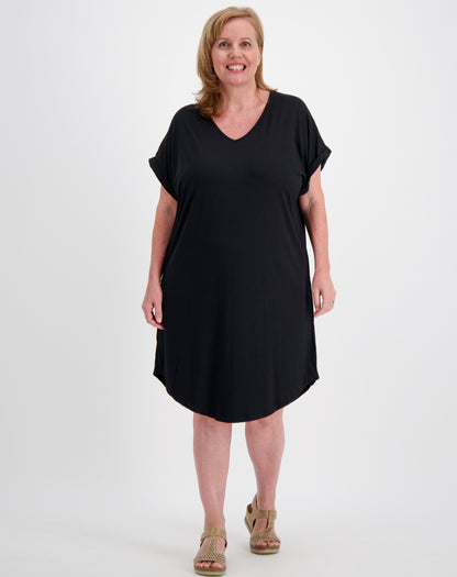 Woman wearing a v neck black curved hem tee dress on a white background