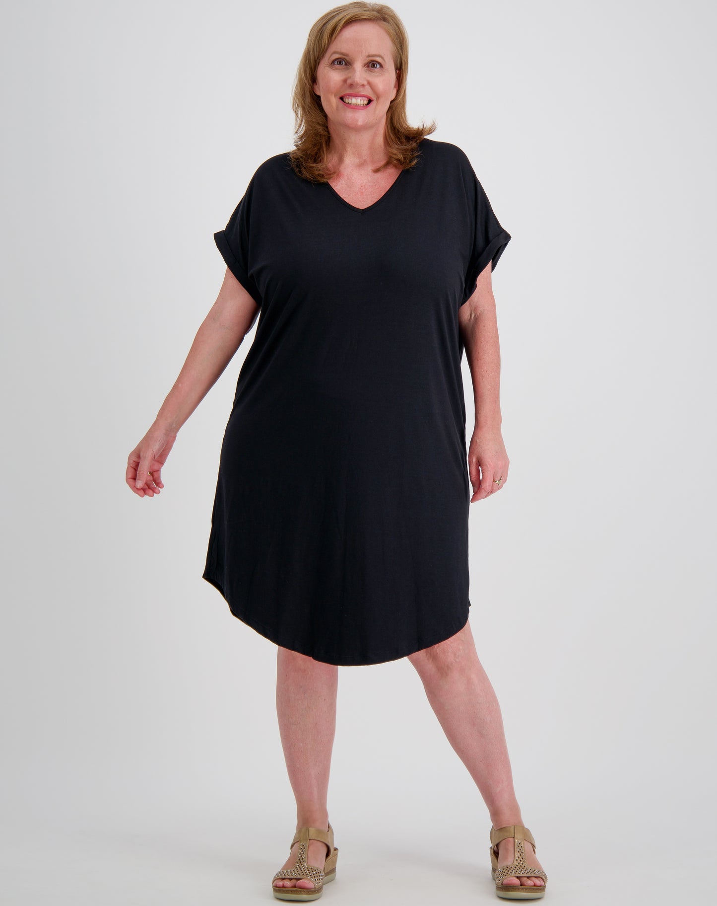 Woman wearing a black modal curved  tee dress on a white background