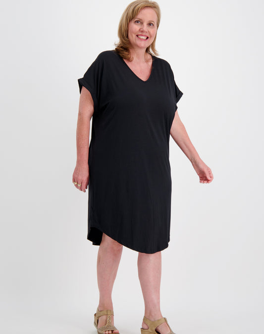 Woman wearing a black curved hem tee dress by miss seafari on a white background