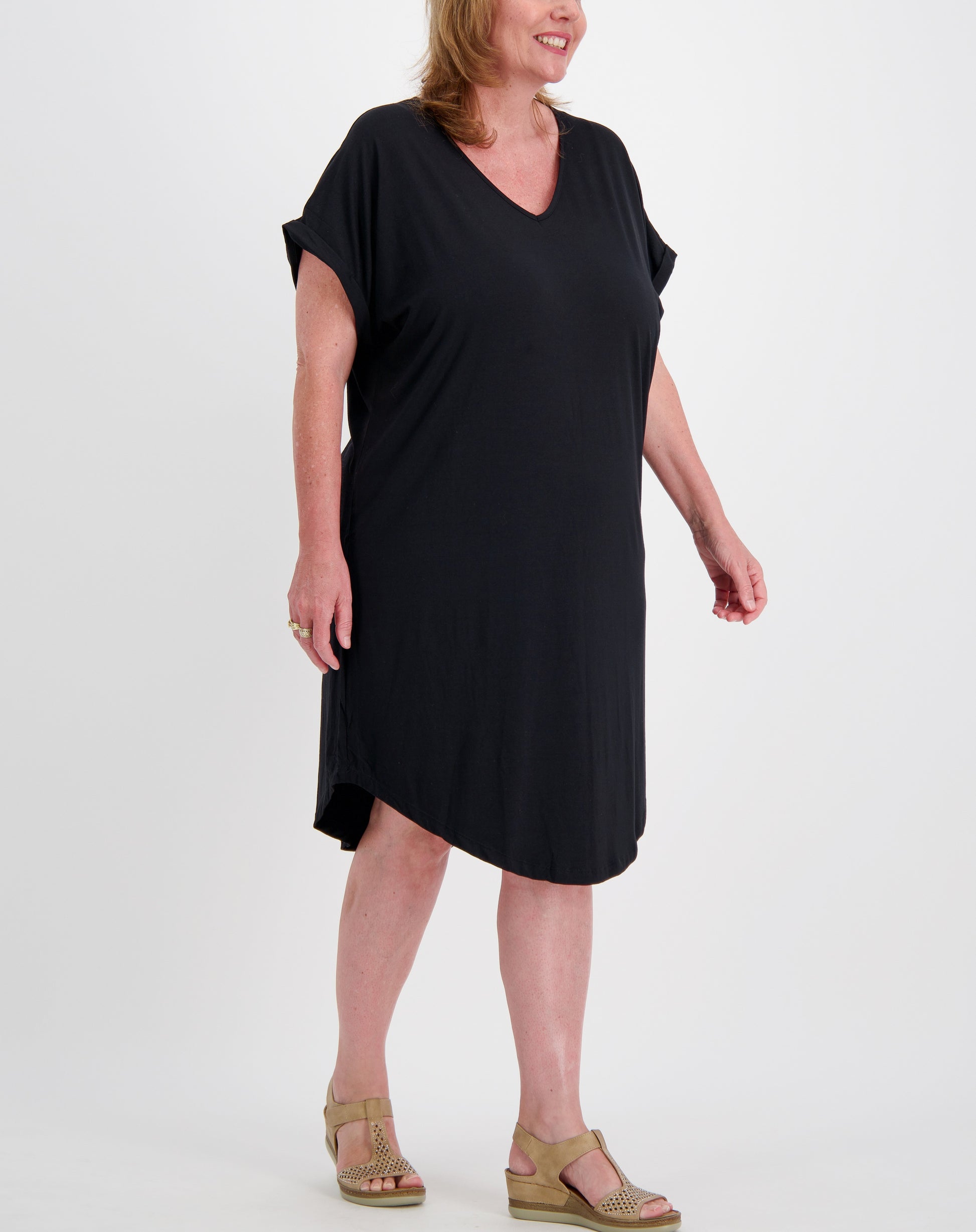 Curve woman wearing a black modal comfort tee dress on a white background