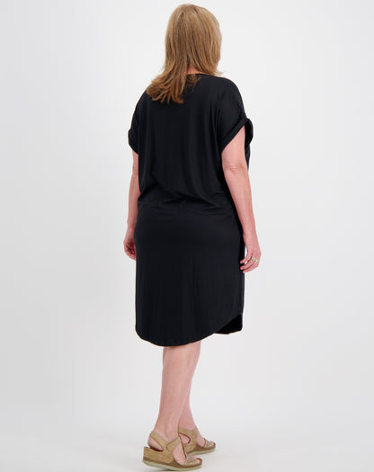 Woman wearing a black dress showing back of dress with curved hem