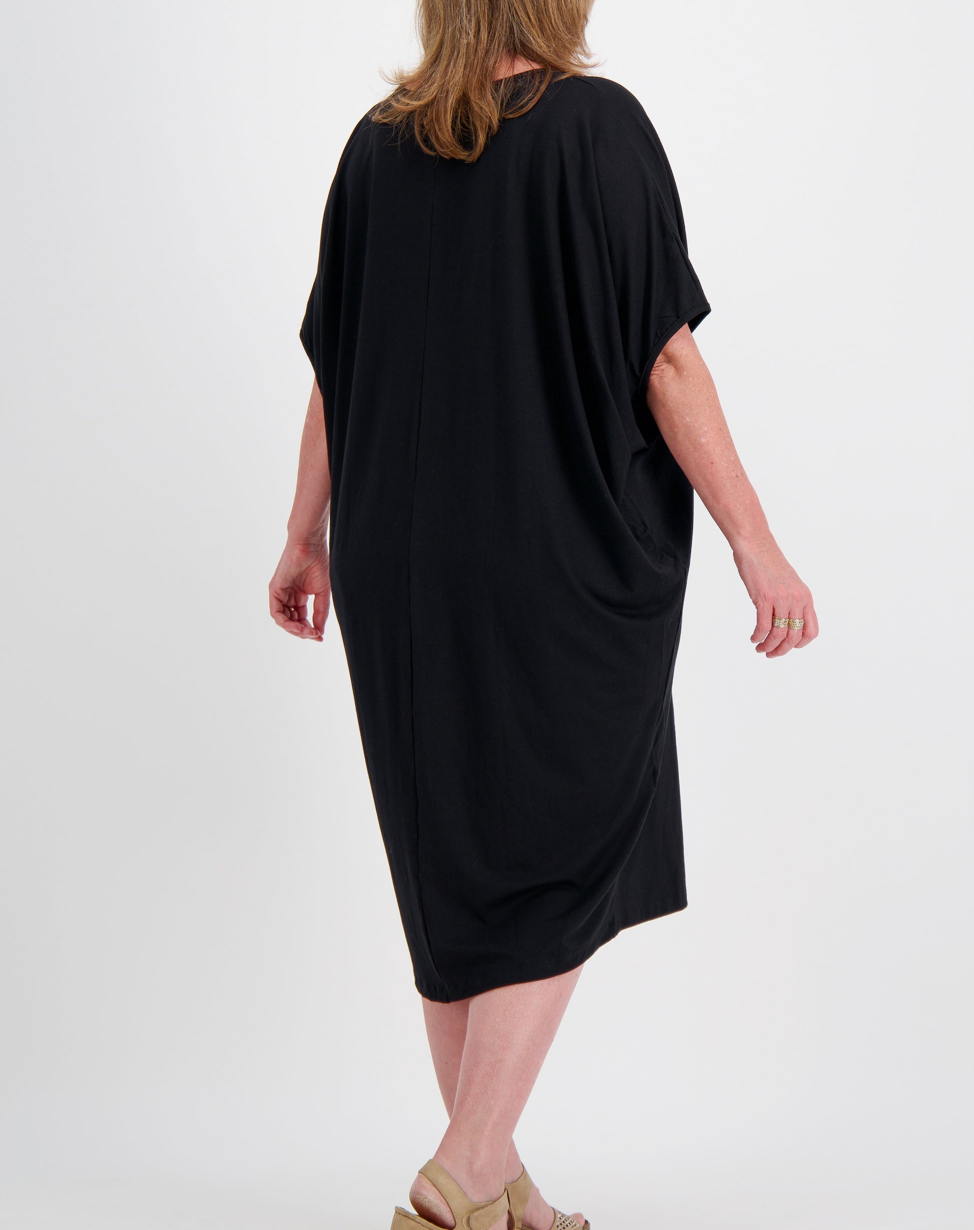 black comfort dress in black modal worn by a size 16 woman on a white background