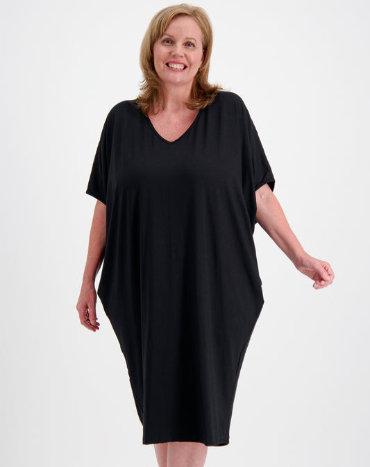 Woman wearing a black comfort dress in black modal by miss seafari on a white background