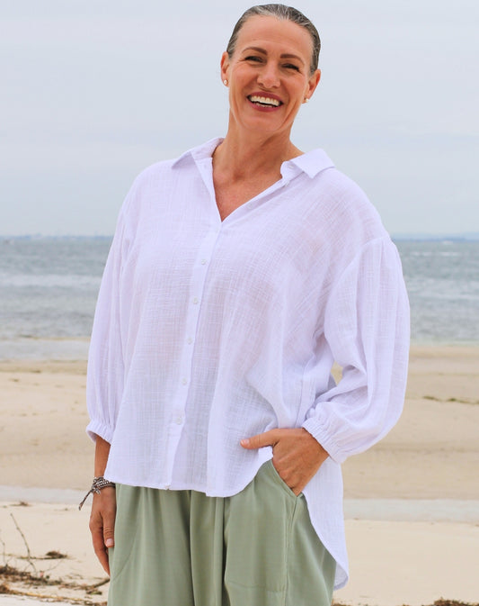 woman on beach with a white cotton comfort shirt to coverup at beach