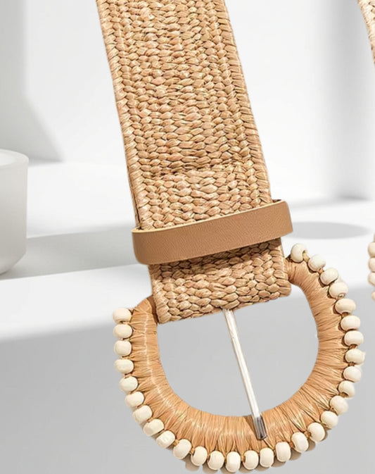 Woven belt with a decorative wooden buckle on a light background