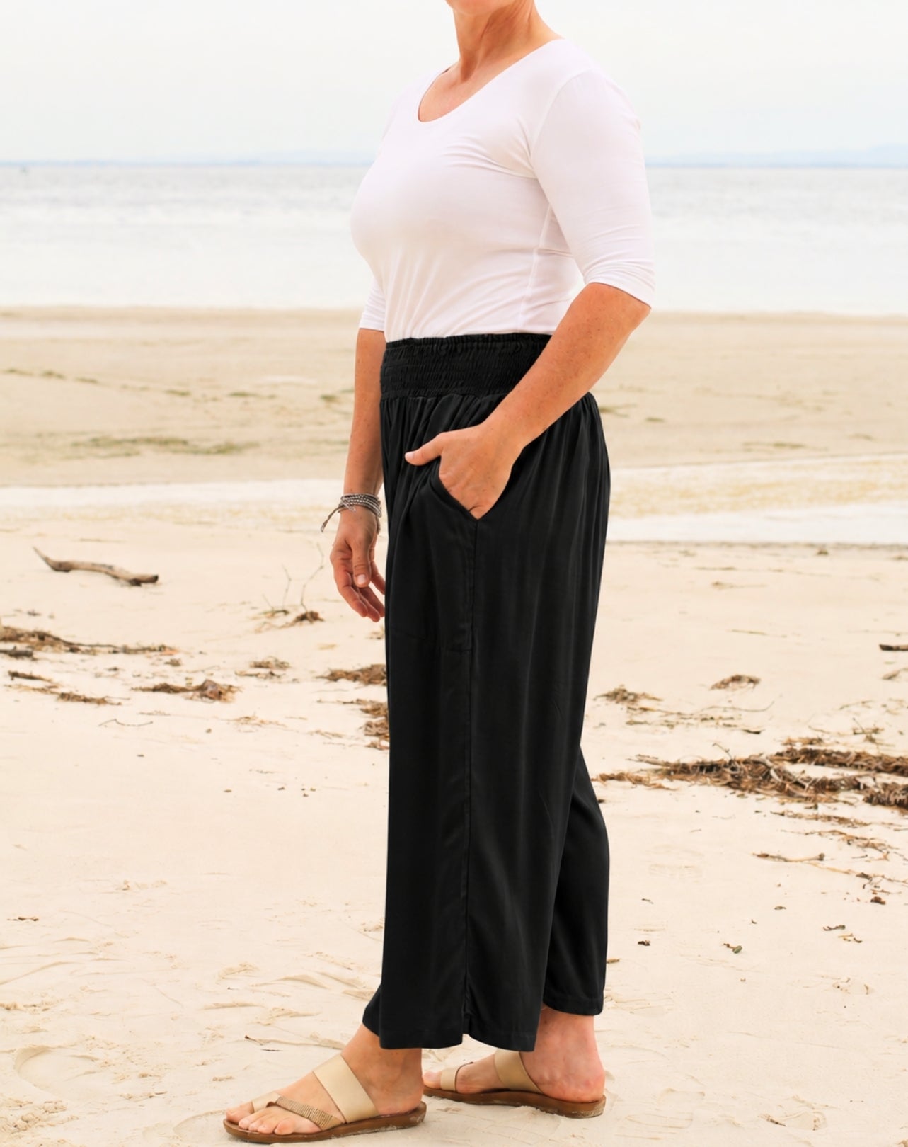 side view of everyday pant showing pocket shirred waist and relaxed wide leg