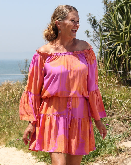 fiesta dress in orange palms by miss seafari worn off shoulder at beach