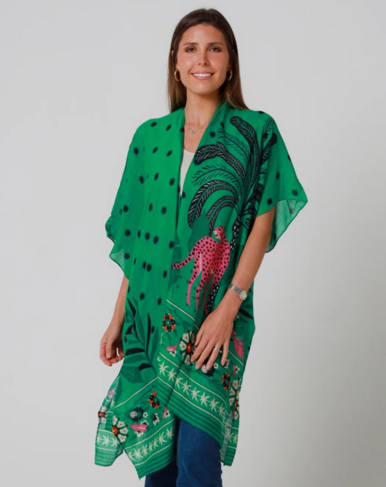 Woman wearing a green patterned kimono with leopard against a plain background