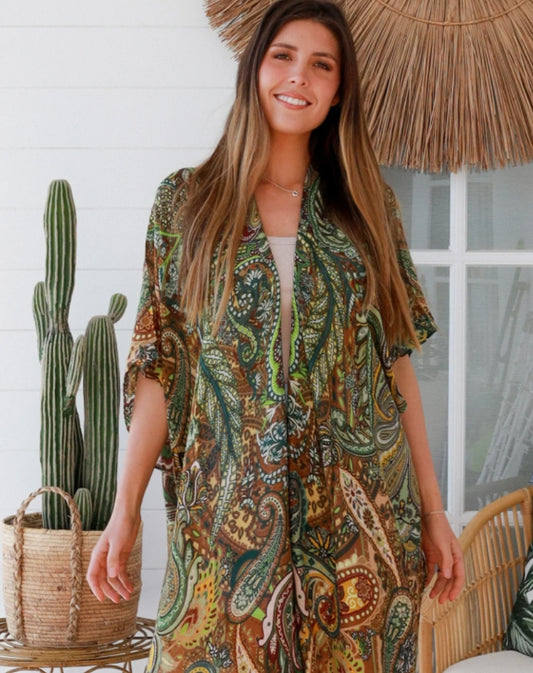 Woman wearing a PAISLY patterned kimono standing in front of a cactus plant indoors.