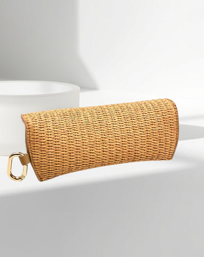 back of rattan glasses case showing gold clasp and clip for handbag