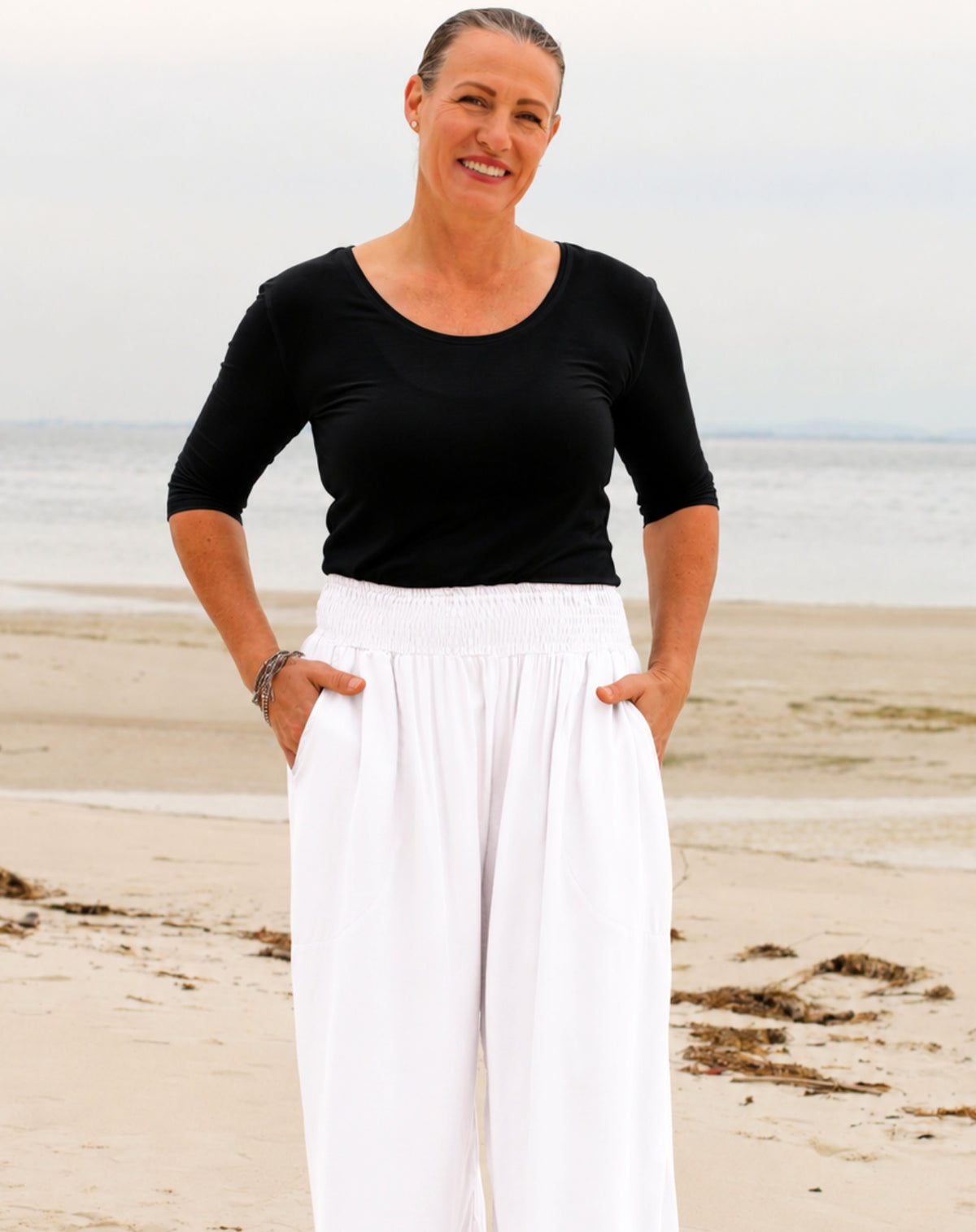 scoop tee in black modal tucked in white resort pant 