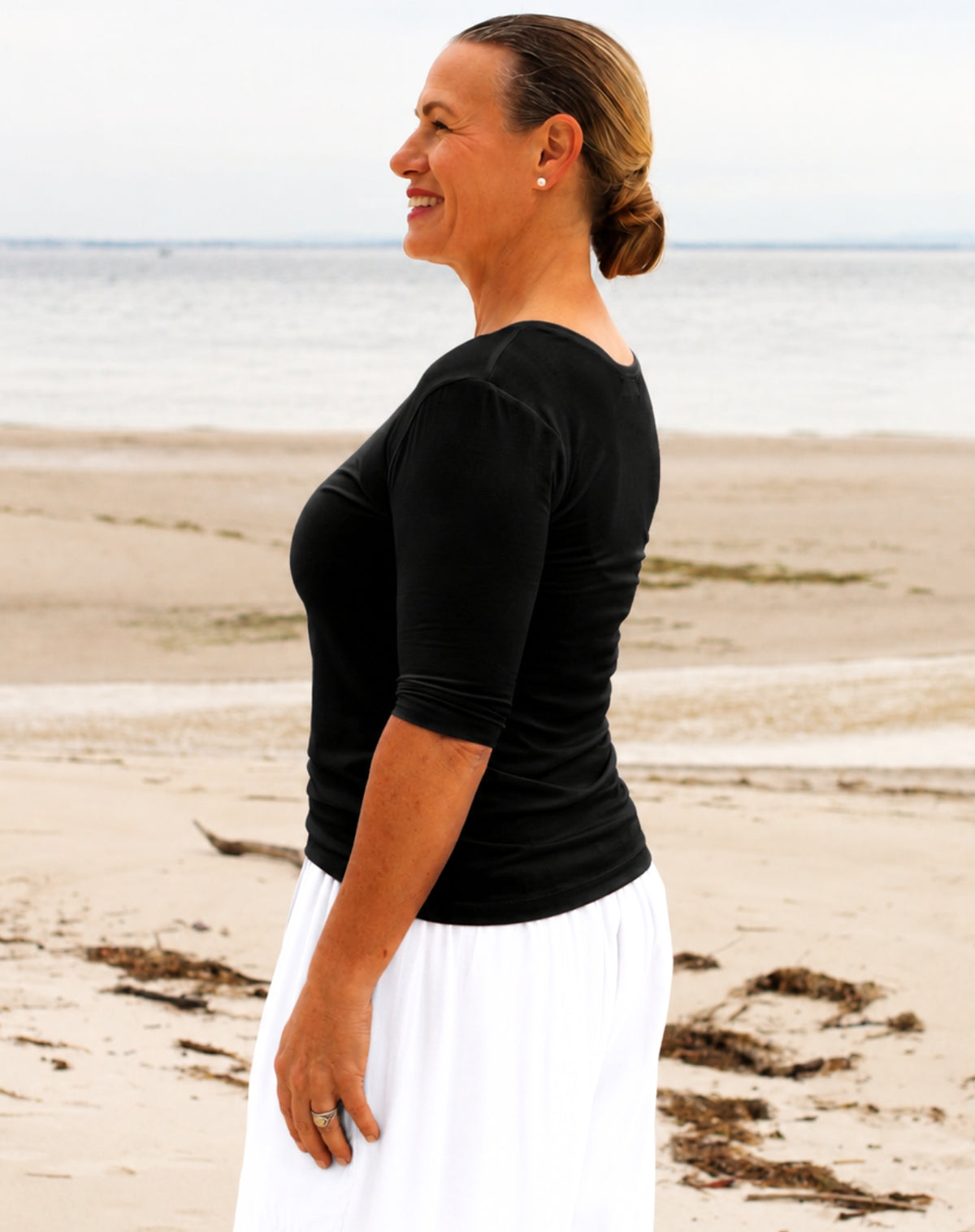 woman wearing black 3/4 sleeve black jersey scoop tee with white palazzo pants