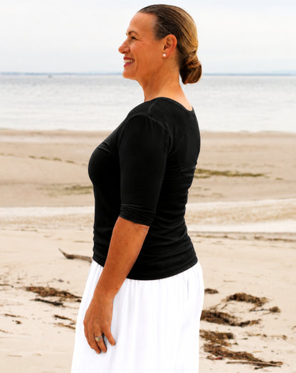 woman wearing black 3/4 sleeve black jersey scoop tee with white palazzo pants
