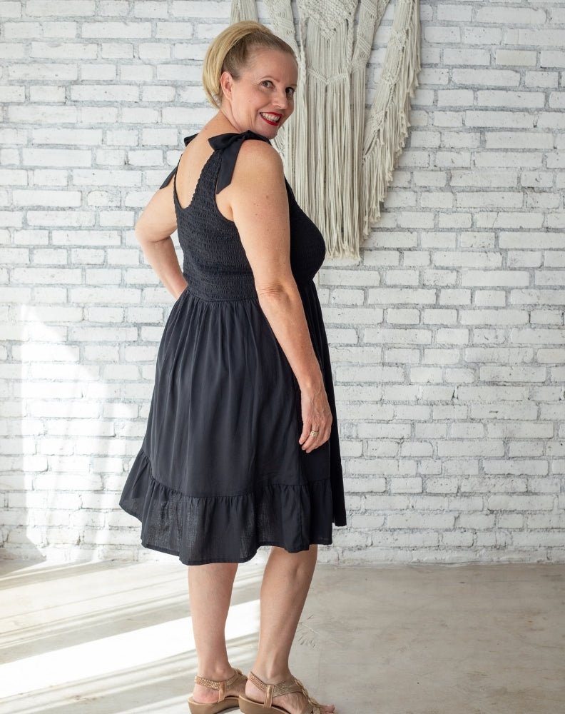 mature woman in shirred black dress worn on holidays 