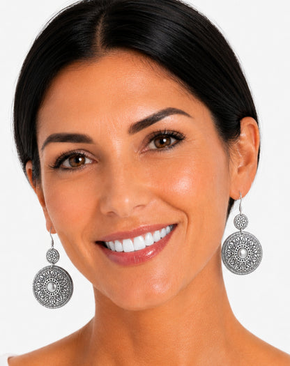 silver round disc earrings on model in studio