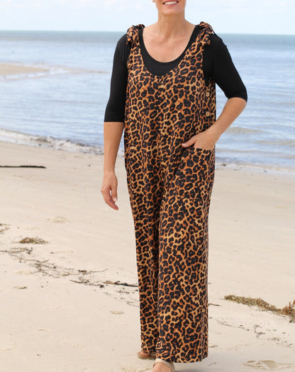 Person wearing a leopard print jumpsuit on a beach designed by Miss Seafari Australia
