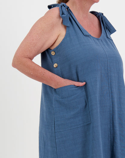 Blue sleeveless dress smock dress with button details on a white background