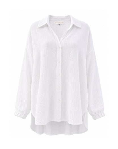 A white long-sleeve button-up shirt with a relaxed, oversized fit, featuring a pointed collar, subtle vertical crinkle texture, and elasticized cuffs, shown against a plain white background.