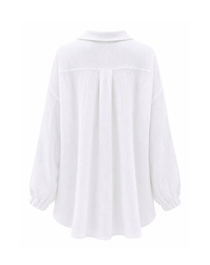 A white long-sleeve blouse with a textured, crinkled fabric, featuring a pointed collar, a front button placket, and gathered elastic cuffs, shown from the back on a white background.